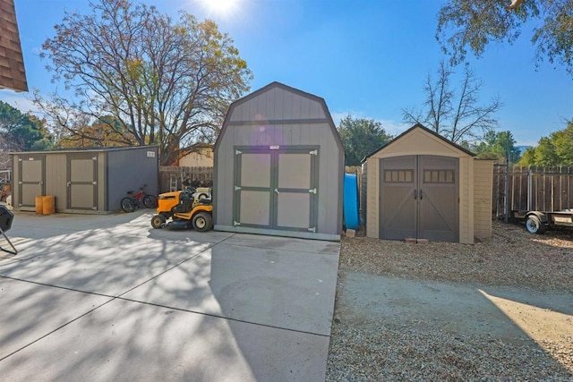 view of shed featuring fence