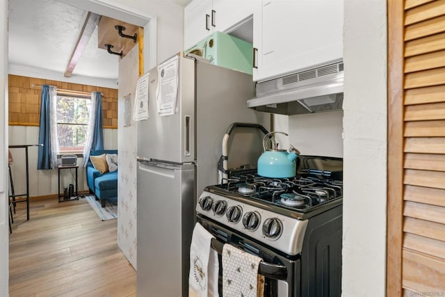 kitchen with white cabinetry, ventilation hood, light hardwood / wood-style floors, and stainless steel gas stove