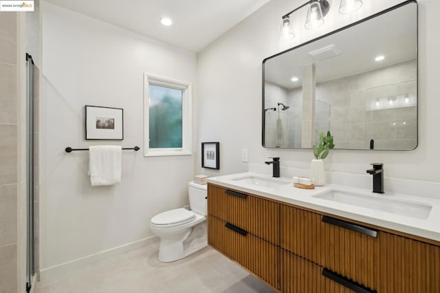 bathroom with an enclosed shower, vanity, and toilet