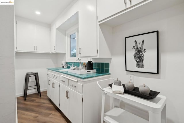 kitchen featuring white cabinetry, sink, and dark hardwood / wood-style flooring