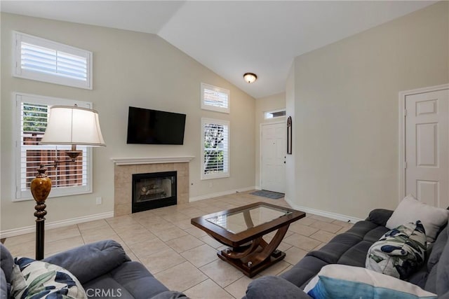 living room featuring high vaulted ceiling, a fireplace, baseboards, and light tile patterned floors