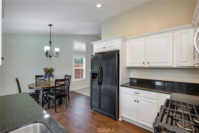 kitchen featuring white cabinetry, vaulted ceiling, black appliances, and dark hardwood / wood-style floors