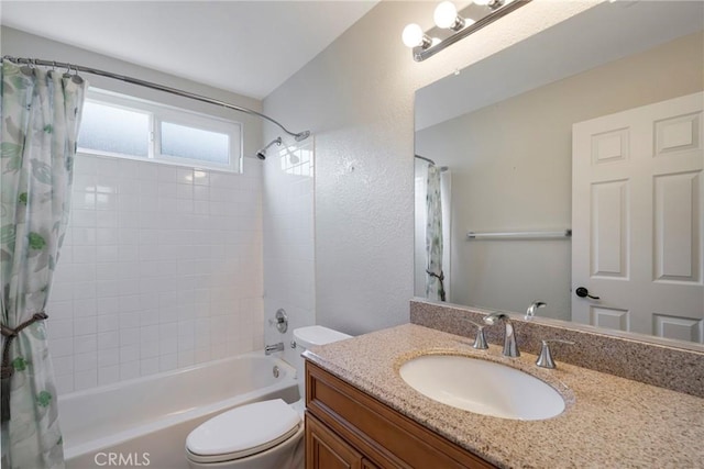 bathroom with toilet, shower / tub combo, a textured wall, and vanity