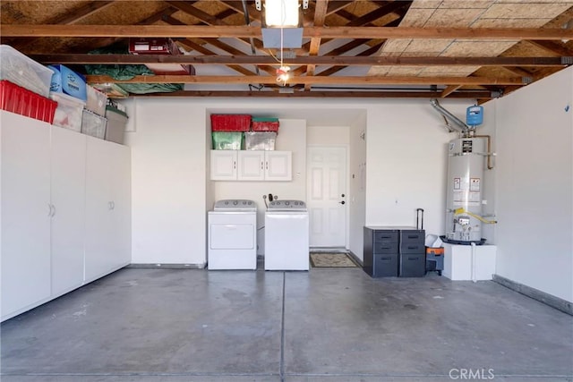 garage with water heater and washing machine and clothes dryer