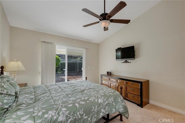 carpeted bedroom with access to outside, ceiling fan, and vaulted ceiling