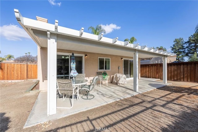 back of house featuring fence, a patio, and stucco siding