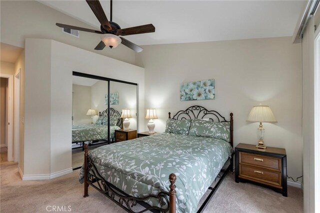 carpeted bedroom with lofted ceiling, a closet, and ceiling fan