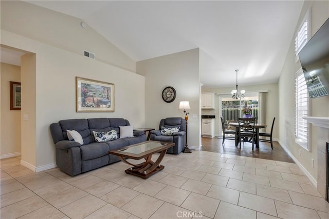 living room featuring a fireplace, light tile patterned floors, visible vents, high vaulted ceiling, and baseboards