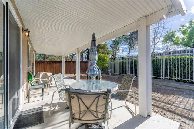 view of patio featuring a fenced backyard and outdoor dining space