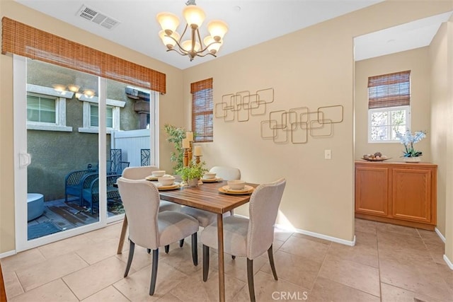 tiled dining space with a chandelier