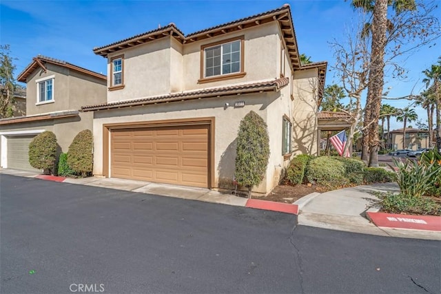 mediterranean / spanish-style house with a garage