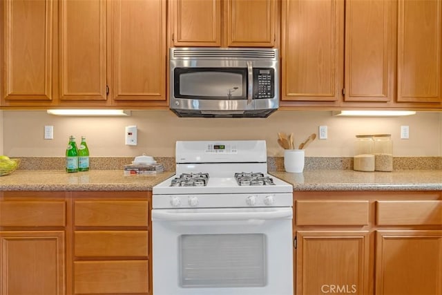 kitchen featuring white range with gas cooktop