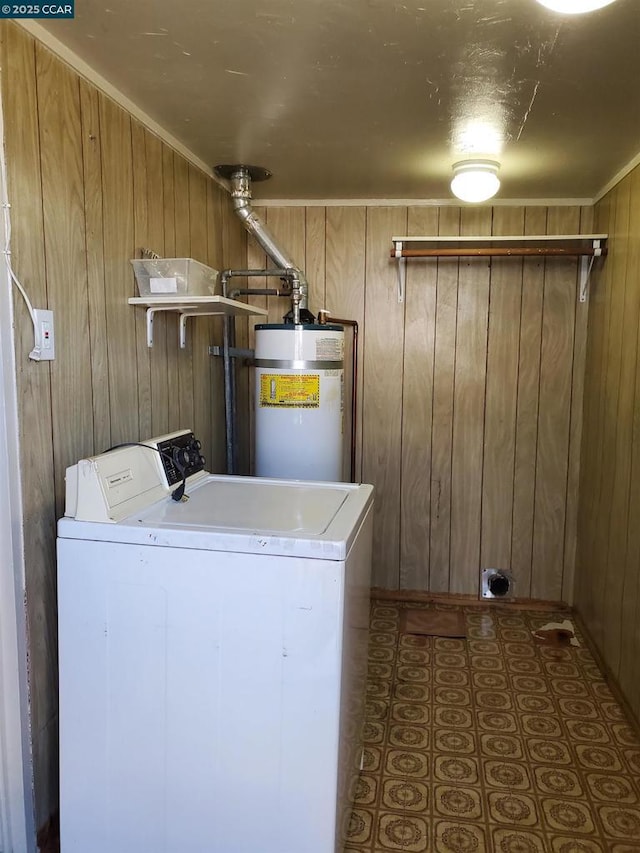 washroom with washer / clothes dryer, wooden walls, and strapped water heater