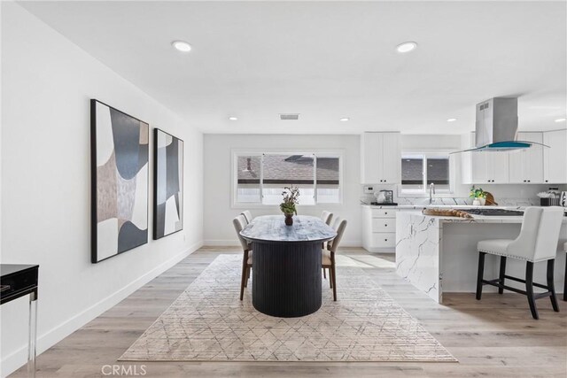 dining room with sink and light hardwood / wood-style floors