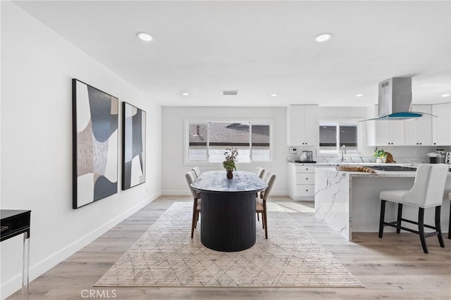 dining area featuring sink and light hardwood / wood-style flooring