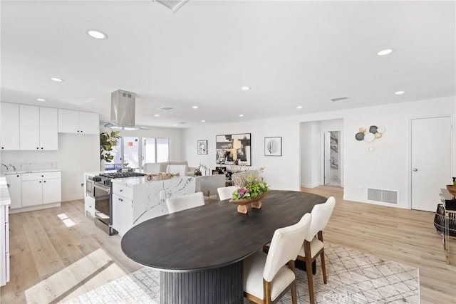 dining space with light hardwood / wood-style floors