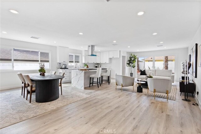 dining room featuring sink and light wood-type flooring