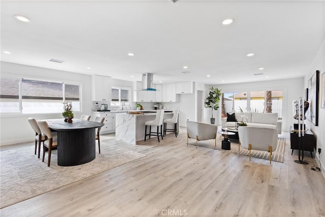 dining area with sink and light hardwood / wood-style flooring