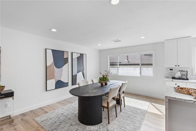 dining space with light hardwood / wood-style flooring