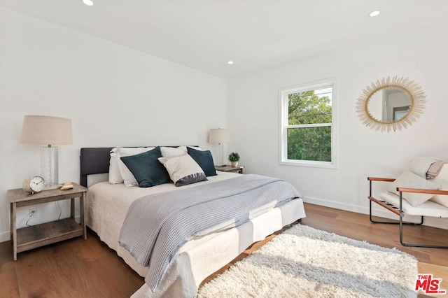 bedroom with dark hardwood / wood-style flooring