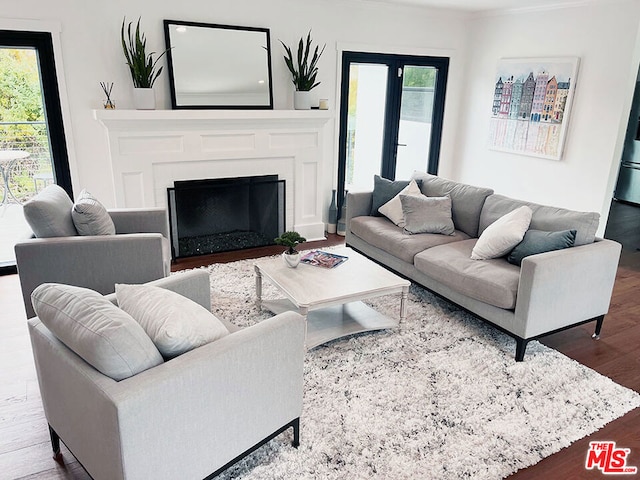 living room with crown molding and hardwood / wood-style floors