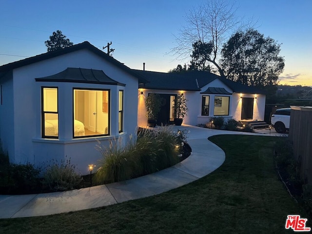 view of front of property with a yard