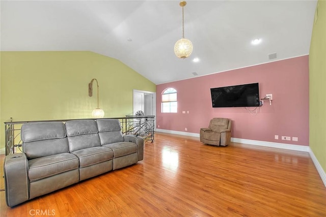 living room with vaulted ceiling and light hardwood / wood-style floors