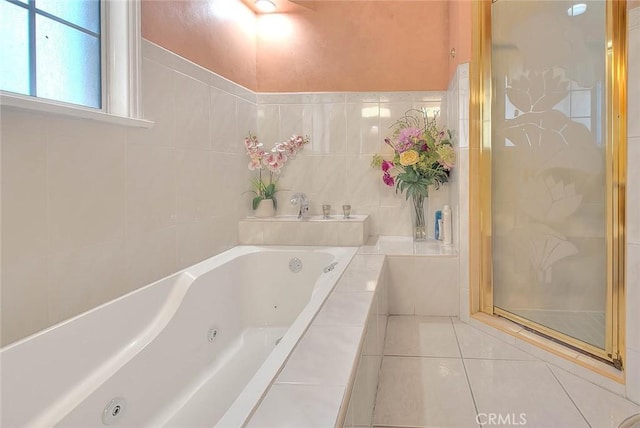 bathroom featuring tile patterned flooring and separate shower and tub