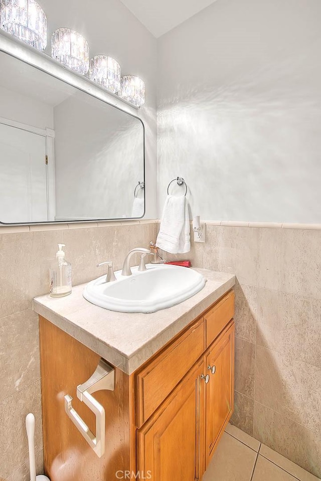 bathroom with tile patterned floors, vanity, and tile walls