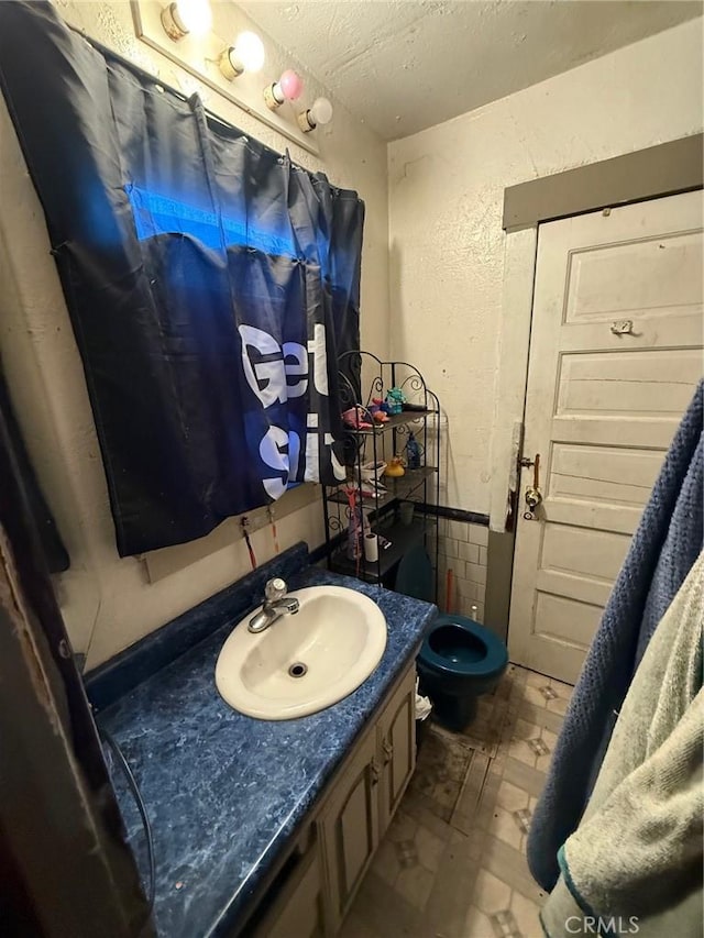 bathroom featuring vanity and a textured ceiling