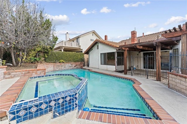 view of swimming pool with an in ground hot tub