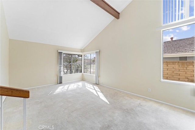 carpeted empty room with beamed ceiling and high vaulted ceiling