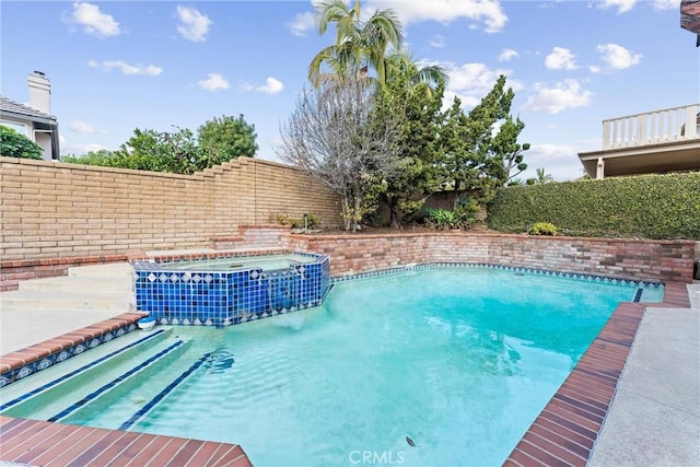 view of pool featuring an in ground hot tub