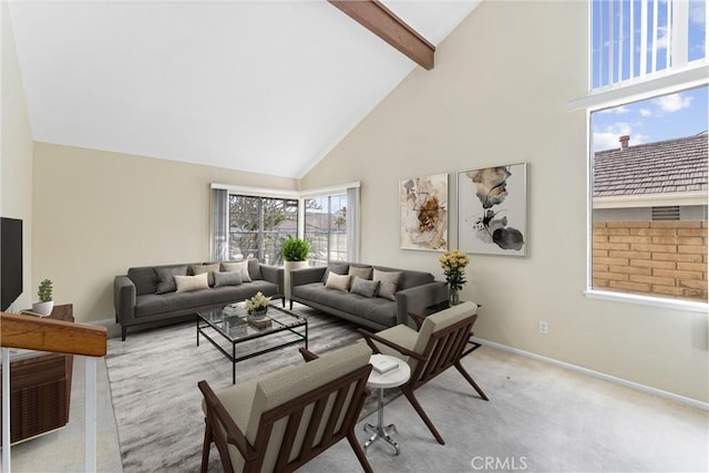 carpeted living room featuring beam ceiling and high vaulted ceiling