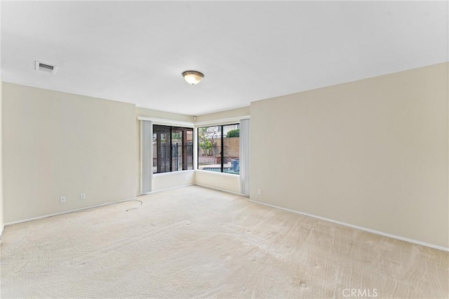 spare room with light colored carpet