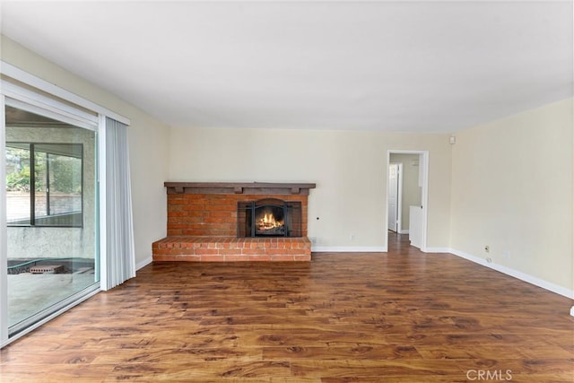 unfurnished living room with dark hardwood / wood-style flooring and a fireplace