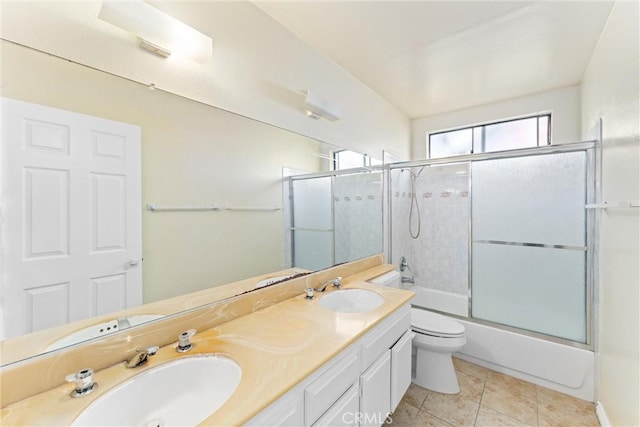 full bathroom with vanity, tile patterned floors, toilet, and combined bath / shower with glass door