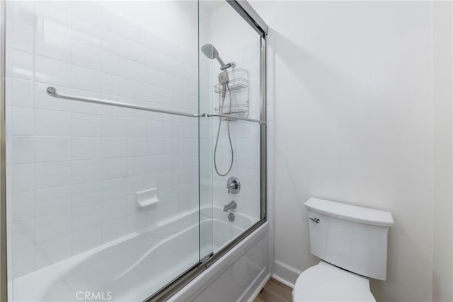 full bathroom with shower / bath combination with glass door and toilet