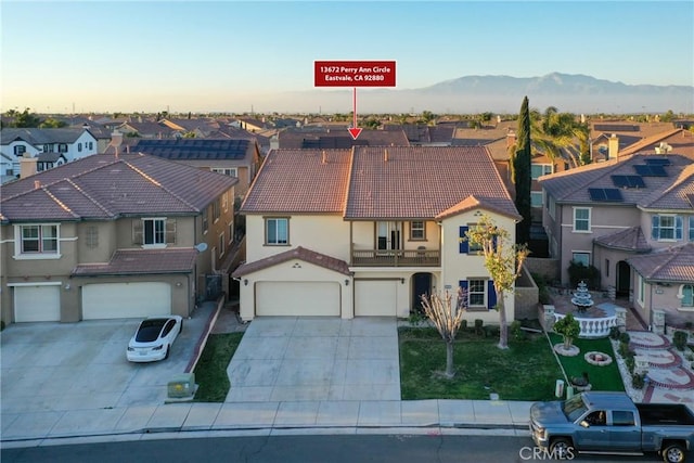 aerial view at dusk featuring a residential view and a mountain view