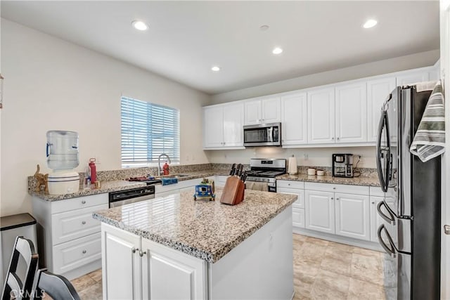 kitchen featuring white cabinetry, a kitchen island, and appliances with stainless steel finishes