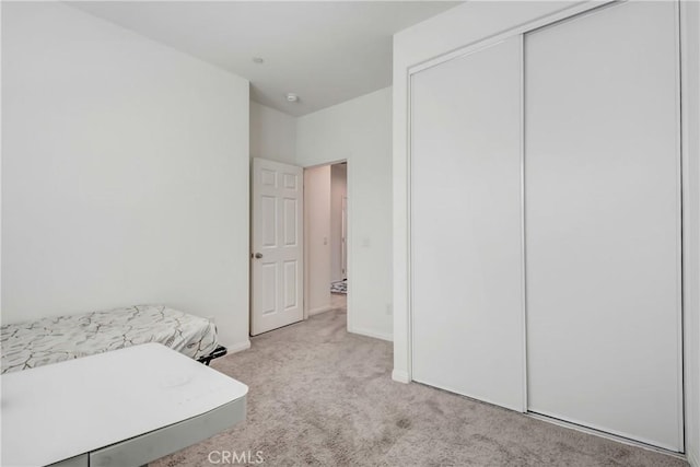 carpeted bedroom with a closet