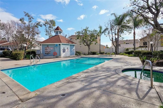 view of pool with a community hot tub and a patio