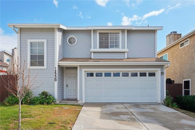 view of front property with a garage and a front yard