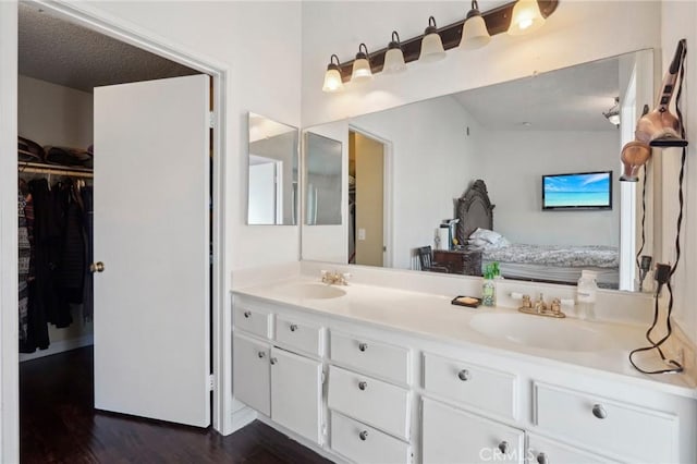 bathroom with vanity, hardwood / wood-style floors, and a textured ceiling