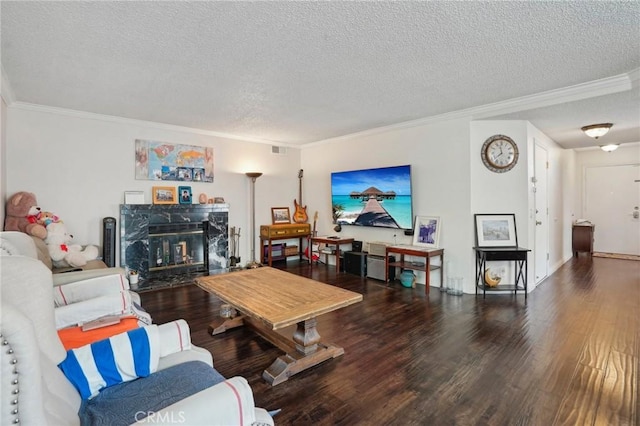 living room with crown molding, a high end fireplace, hardwood / wood-style floors, and a textured ceiling