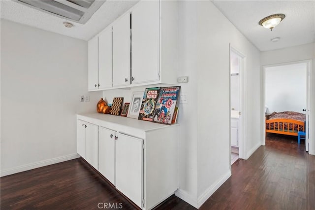 hallway with dark hardwood / wood-style flooring