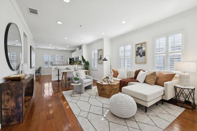 living room featuring light hardwood / wood-style flooring and ornamental molding