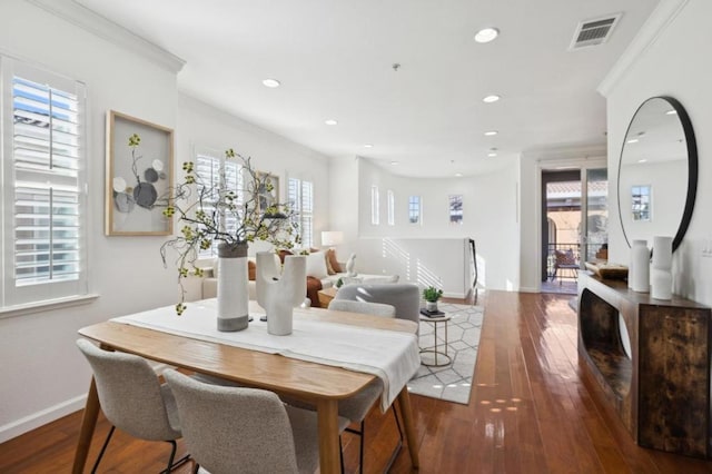 dining room featuring crown molding and dark wood-type flooring