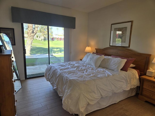 bedroom featuring hardwood / wood-style floors and access to outside