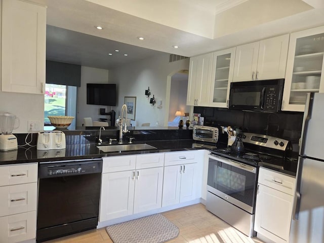 kitchen with white cabinetry, sink, kitchen peninsula, and black appliances